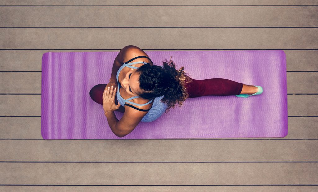 A young woman doing a high lunge on a purple yoga mat, Nova Pathfinder encourages different kinds of fitness to stay sharp body and mind