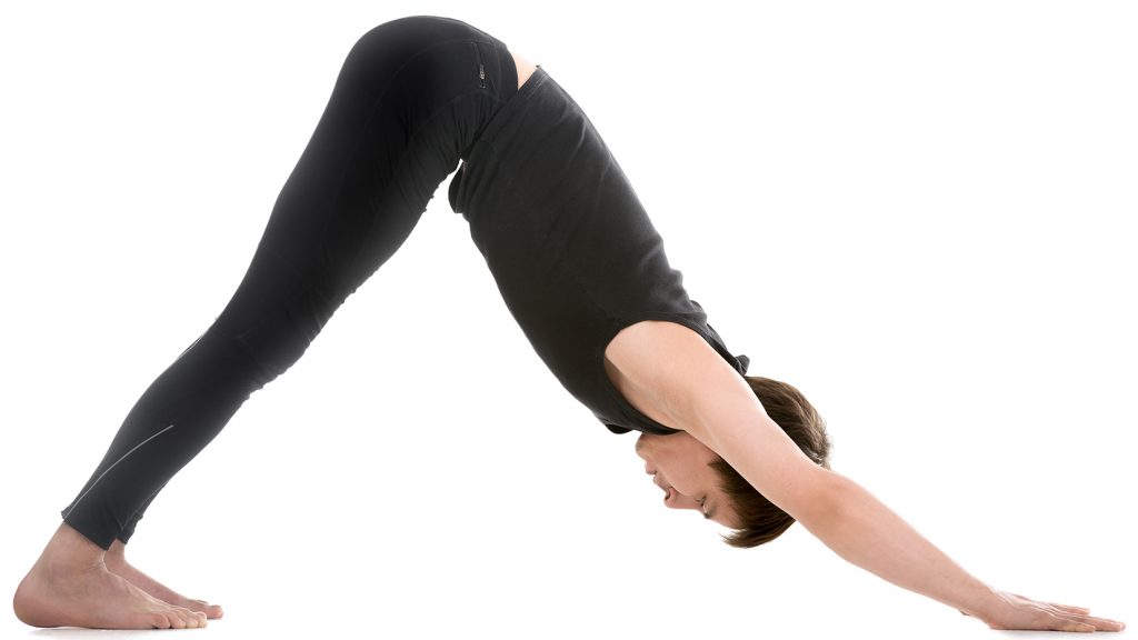 young man dressed in all black stretching his body downward into a v shape